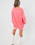 Back view of Show Me Your Mumu Coral Knit Anything Goes Sweater highlighting its loose silhouette and lightweight knit design.