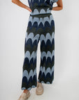 Close-up of Retro Wave Metallic Knit Cropped Pant showcasing shimmery blue wave design and wide-leg silhouette.