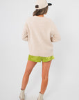 Back view of Cherry On Top Graphic Sweater – beige knit sweater with ribbed hem, ideal for winter layering in trendy casual outfits.
