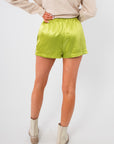 Back view of Key Lime Green Silky Shorts highlighting the relaxed fit and shiny fabric, great for stylish summer wear.