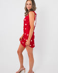 Side view of Cherry Cola Polka Dot Mini Dress showing sleeveless cut and open back tie detail, a chic choice for date nights or Valentine's events.