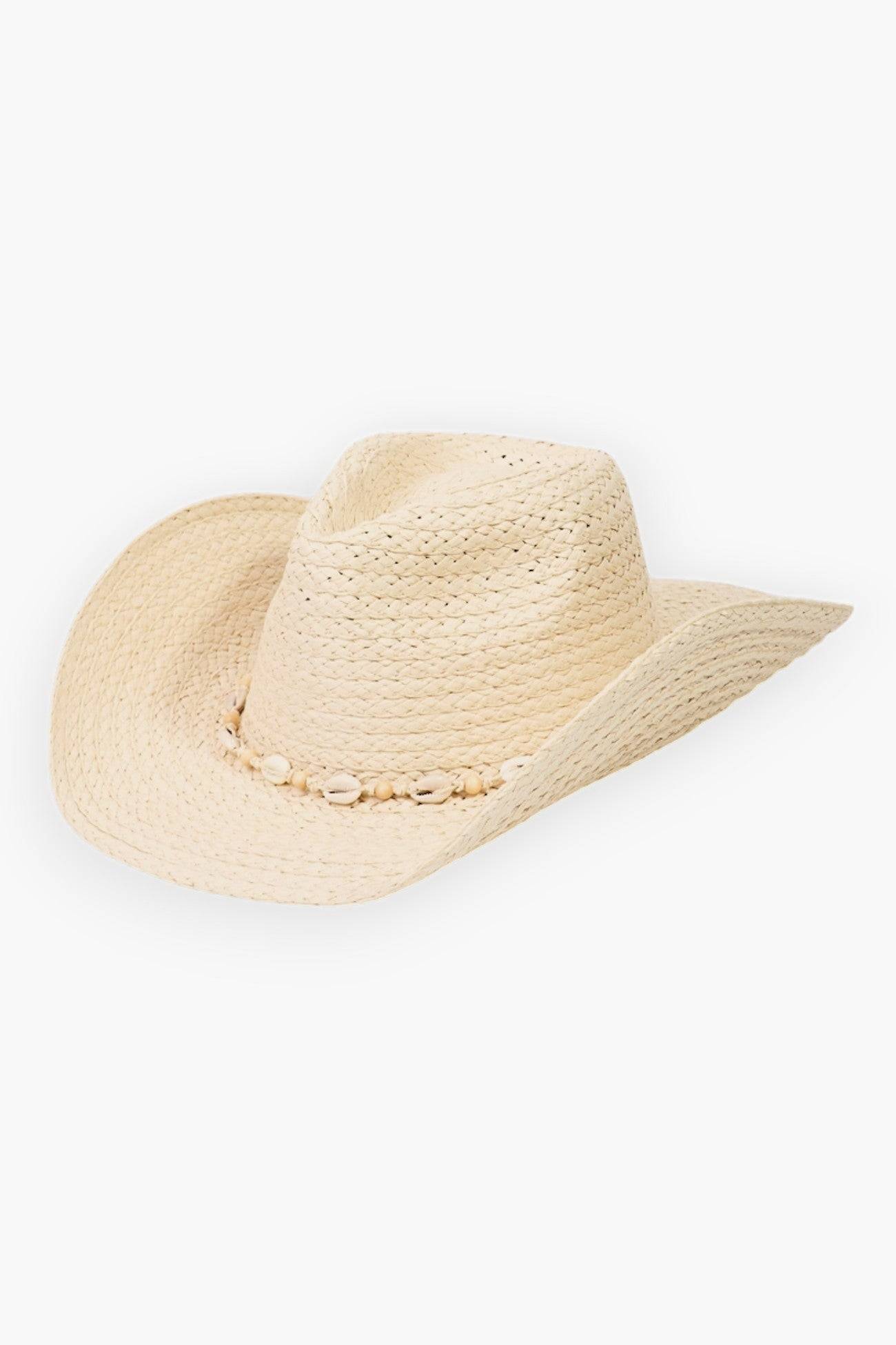 Cowrie Shell Straw Braided Cowboy Hat in ivory with a boho-chic design. Features a woven straw construction and decorative cowrie shell band, perfect for beach days and festivals.