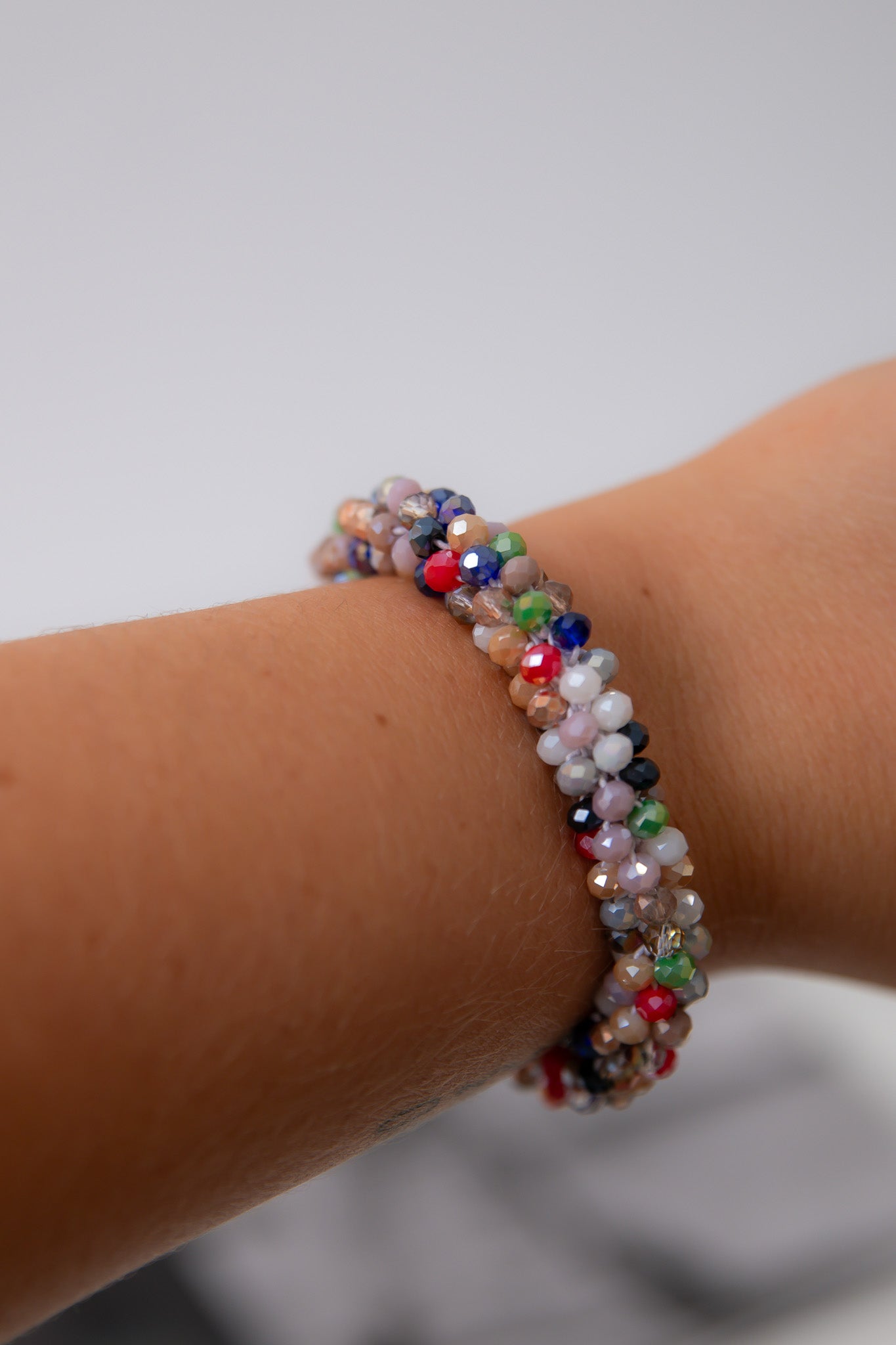 Colorful Seed Bead Bracelet – Lightweight stretchy bracelet with multicolor beads shown worn on wrist, ideal for stacking and daily wear.
