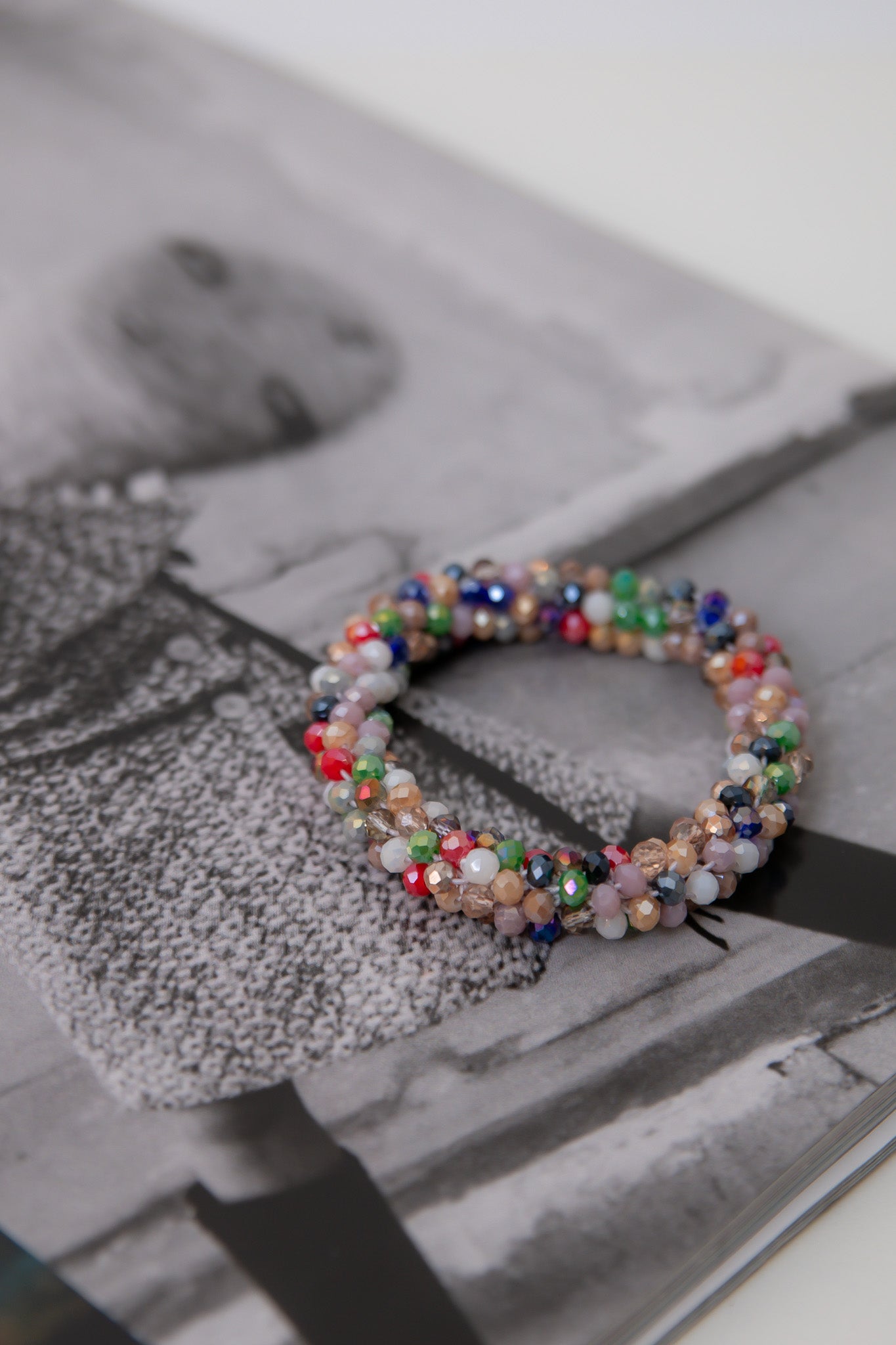 Colorful Seed Bead Bracelet – Stretchy multi color stackable jewelry featuring vibrant beads, displayed on a fashion magazine background.