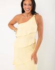 Close-up of the Andie Yellow Layered One Shoulder Maxi Dress highlighting the textured fabric and elegant one-shoulder strap detail.