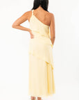 Back view of the Andie Yellow Layered One Shoulder Maxi Dress showcasing its flowing layered design and soft fabric texture.