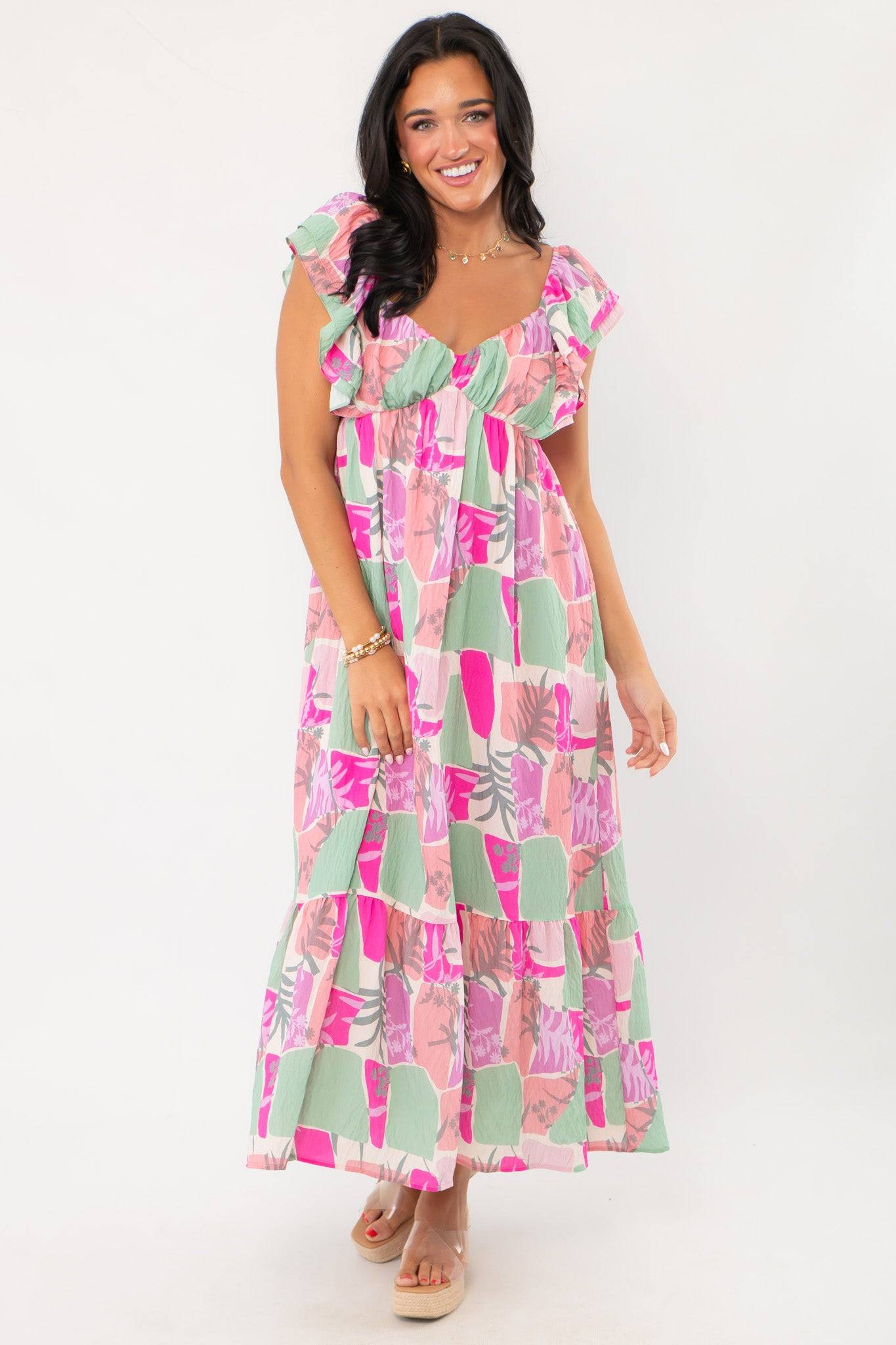THML Pink Palm Ruffle Sleeve Maxi Dress with vibrant tropical print, flutter sleeves, and tiered skirt, perfect for weddings or vacations.