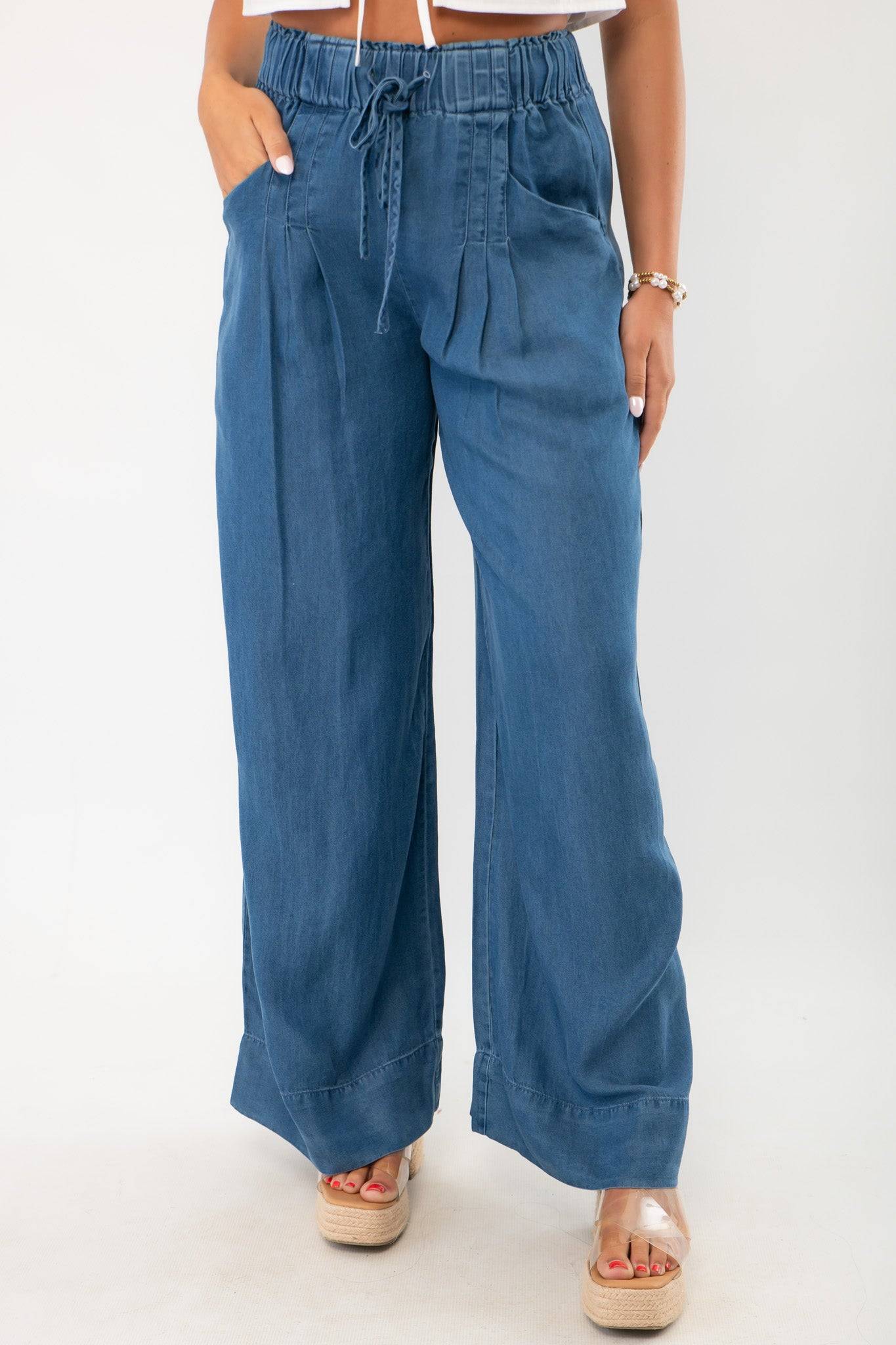 Close-up of Dark Wash Denim Wide Leg Drawstring Pants showcasing pleated front, side pockets, and wide leg silhouette in soft denim fabric.