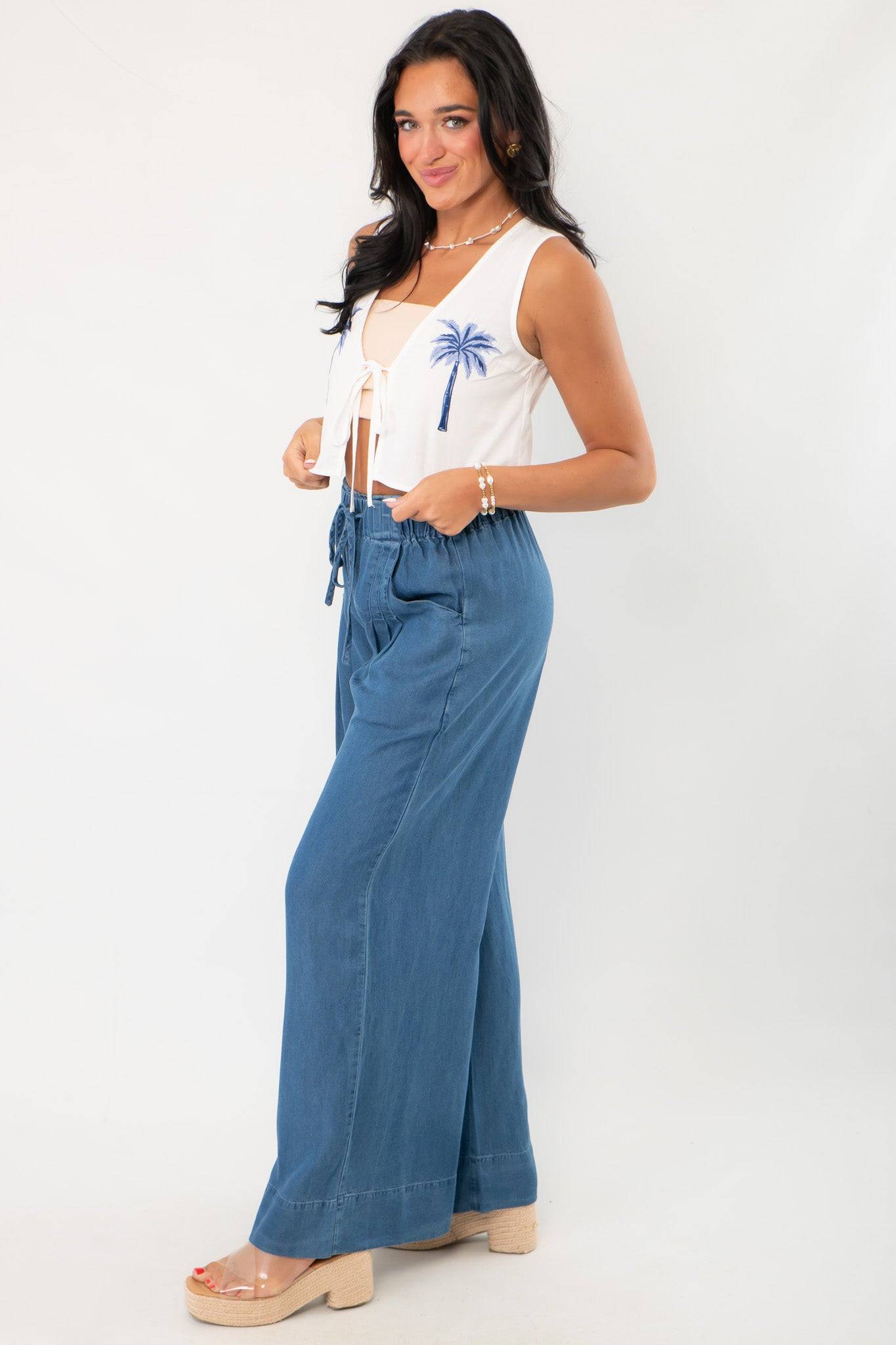 Side view of Versatile Dark Wash Denim Wide Leg Drawstring Pants highlighting the flowy wide leg cut and high-rise elastic waistband.