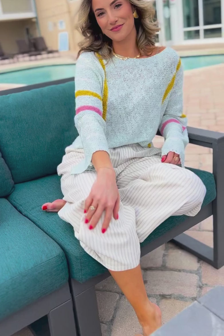 Vibrant Baha Mint Stripe Beach Sweater with pastel accents, styled with striped pants for a relaxed resort look. Perfect for spring break and beach outings.