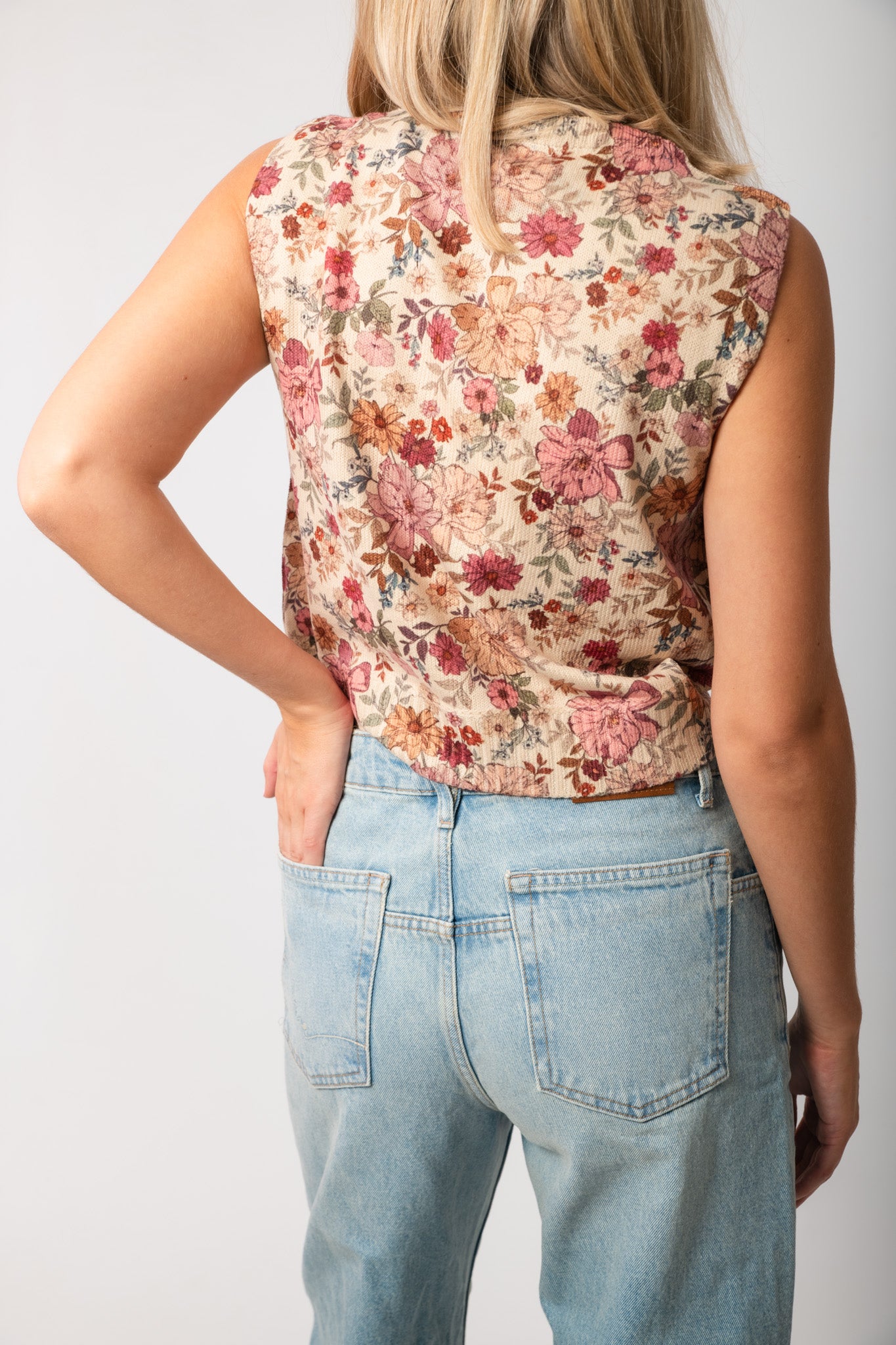Back view of Take It From Here Floral Sleeveless Vest Top with vintage floral knit design, perfect for casual spring and summer outfits.