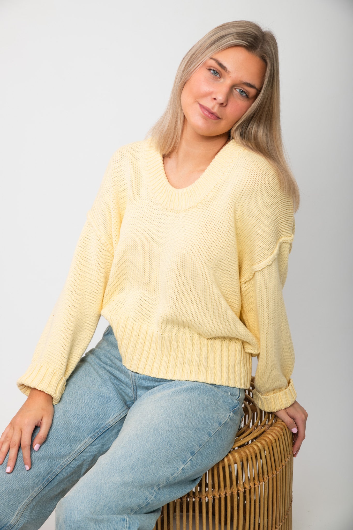 Lemon Sorbet Scoop Neck Sweater in oversized butter yellow knit with ribbed hem and cuffs, styled with light wash jeans for spring.