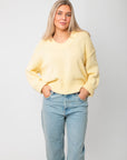 Front view of Lemon Sorbet Scoop Neck Sweater – oversized butter yellow knit top with relaxed fit and scoop neckline, ideal for layering.