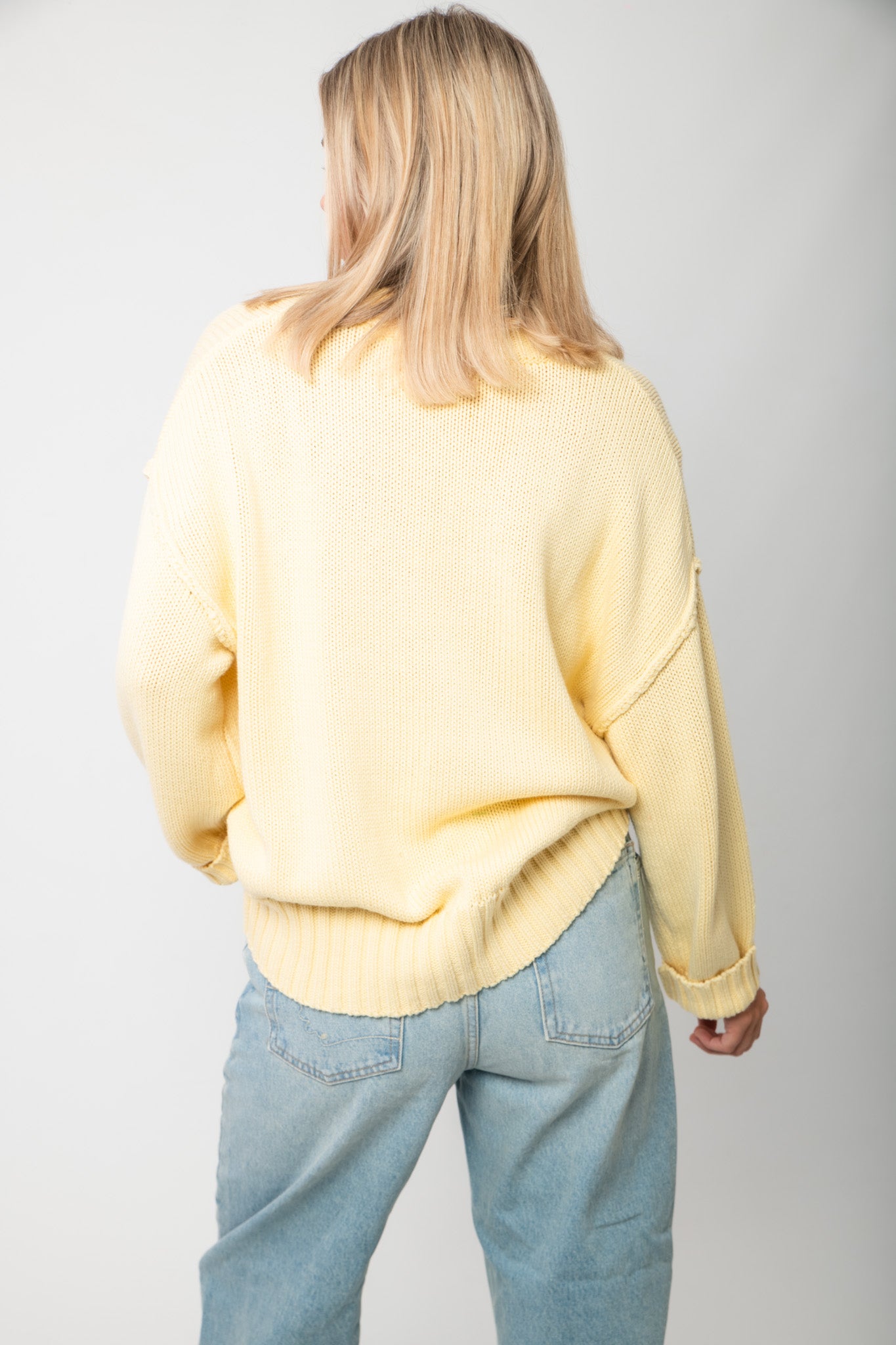 Back view of Lemon Sorbet Scoop Neck Sweater featuring relaxed fit and ribbed detailing in a buttery yellow knit, perfect for spring outfits.