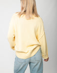 Back view of Lemon Sorbet Scoop Neck Sweater featuring relaxed fit and ribbed detailing in a buttery yellow knit, perfect for spring outfits.