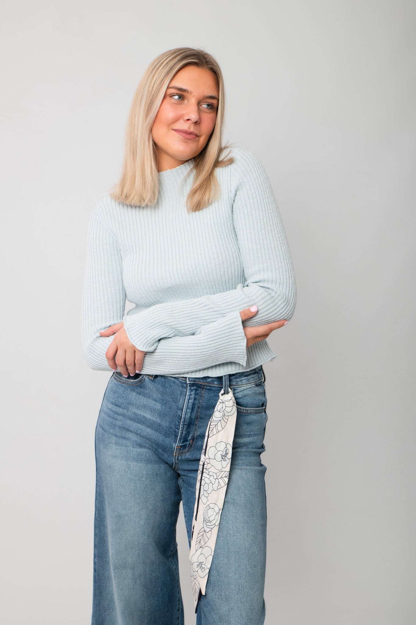 Icey Blue Ribbed Mock Neck Sweater – Fitted knit top with long sleeves and mock neckline, styled with high-waisted jeans for a cozy layered look.