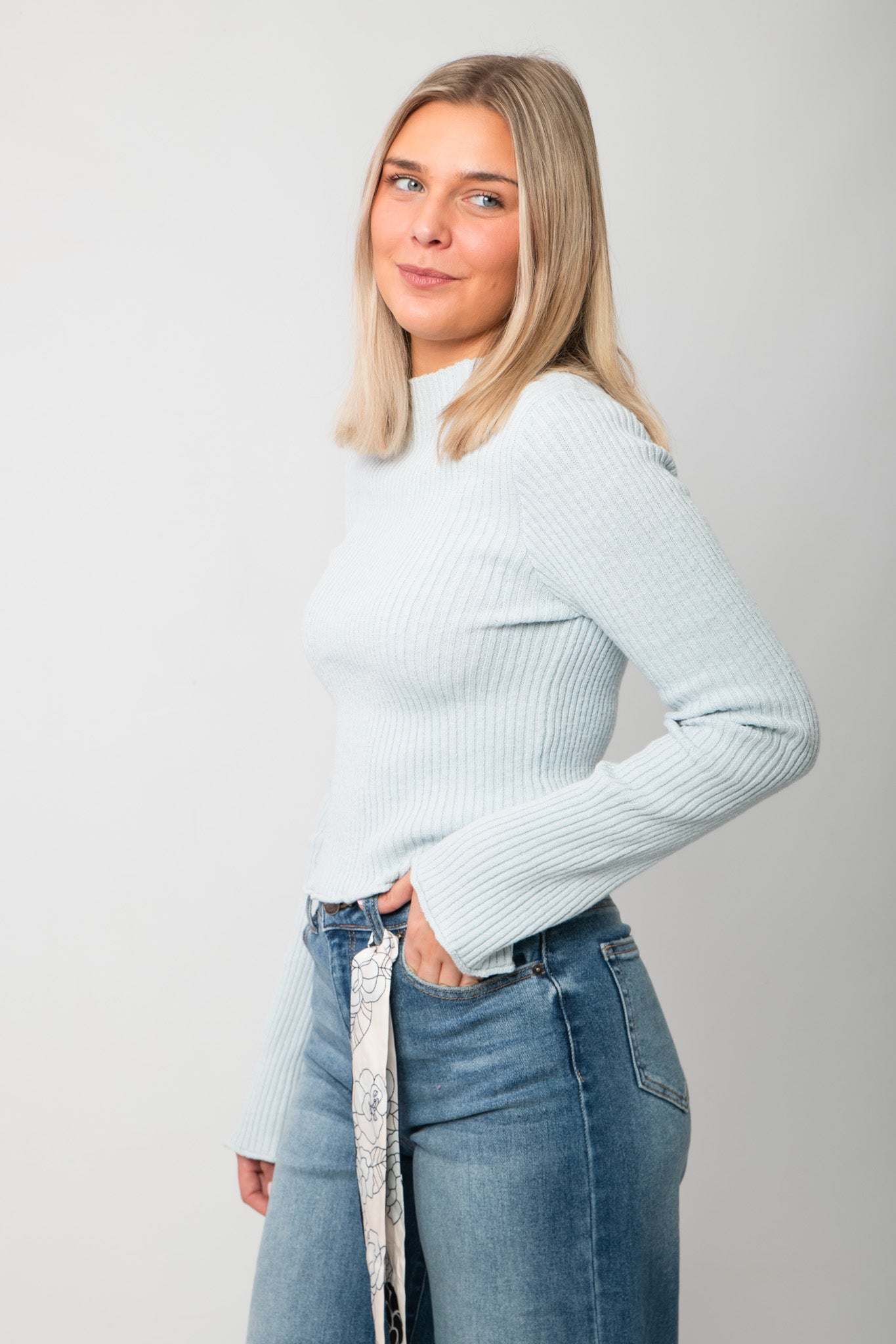 Icey Blue Ribbed Mock Neck Sweater – Side profile highlighting fitted silhouette and mock neck, a versatile layering piece for fall and winter.