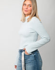 Icey Blue Ribbed Mock Neck Sweater – Side profile highlighting fitted silhouette and mock neck, a versatile layering piece for fall and winter.