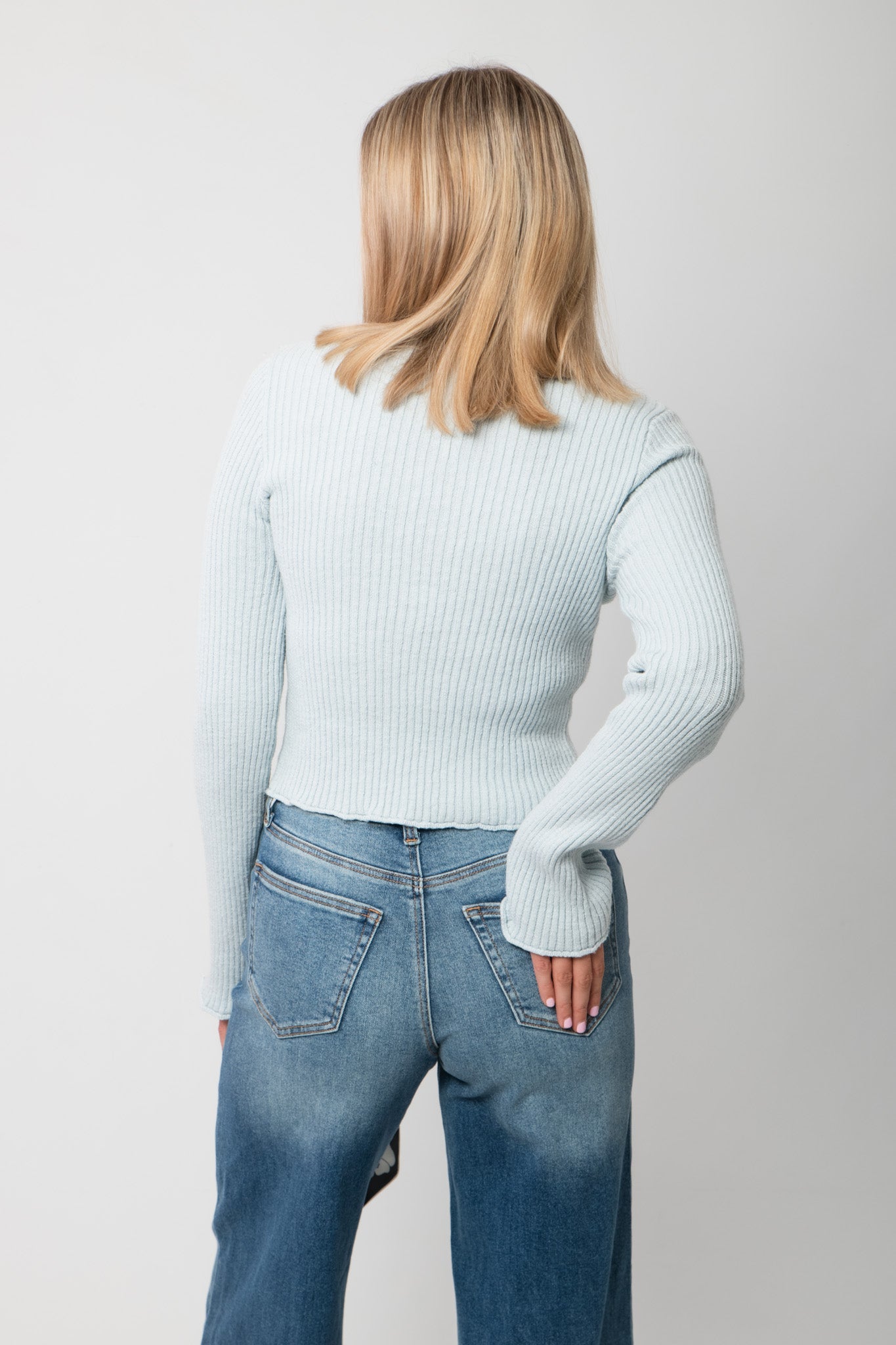 Icey Blue Ribbed Mock Neck Sweater – Back view showing ribbed knit detail and cropped hem, perfect for pairing with high-rise denim.