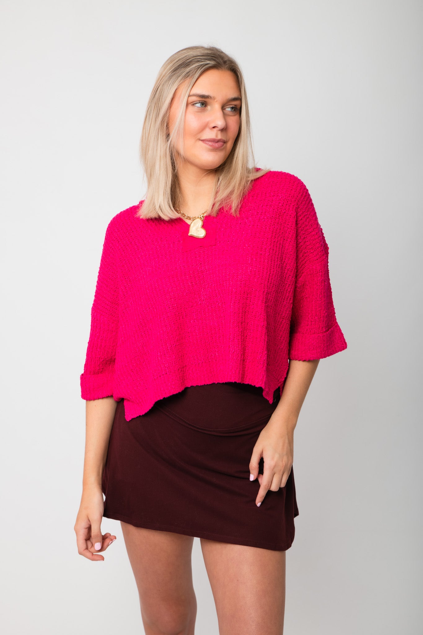 Fuchsia Short Sleeve Crop Sweater – Bright pink v-neck sweater with loose short sleeves and cropped cut, styled for a trendy outfit.
