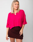 Fuchsia Short Sleeve Crop Sweater – Bright pink v-neck sweater with loose short sleeves and cropped cut, styled for a trendy outfit.