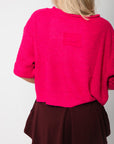 Back view of Fuchsia Short Sleeve Crop Sweater – Oversized pink knit with short sleeves and relaxed hem, ideal for layering or lounging.