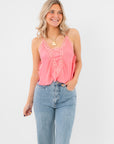 Free People Conch Shell Pink Someone Like You Cami with lace trim, styled with high-waisted jeans for a romantic casual look.