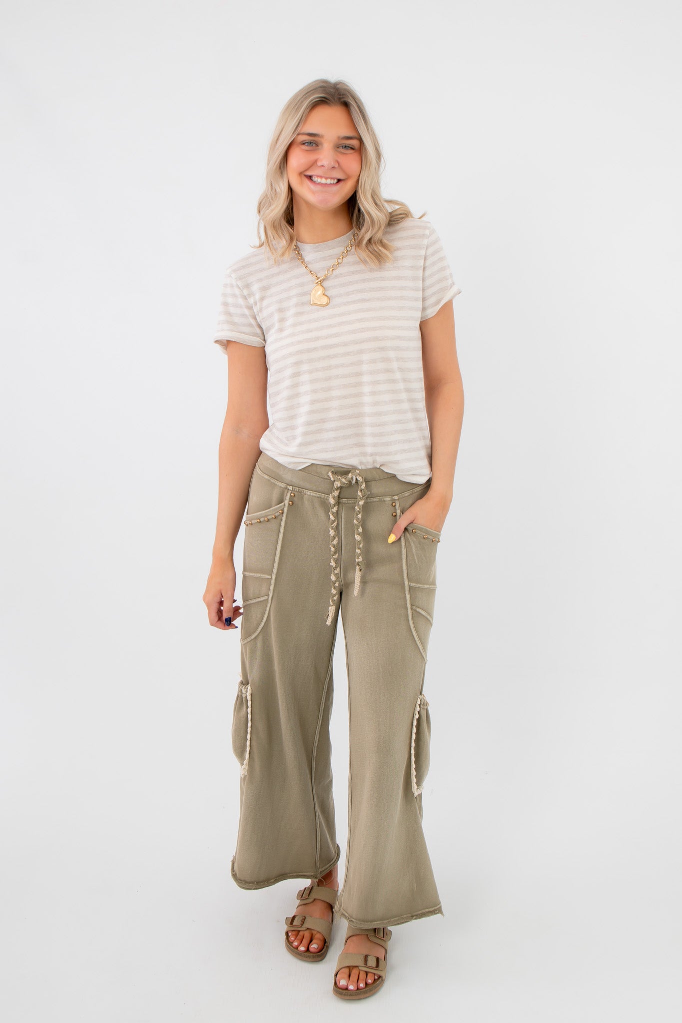 Smokey Sage Cactus Blossom studded wide leg pants styled casually with a striped tee, showcasing relaxed fit and boho-chic versatility.