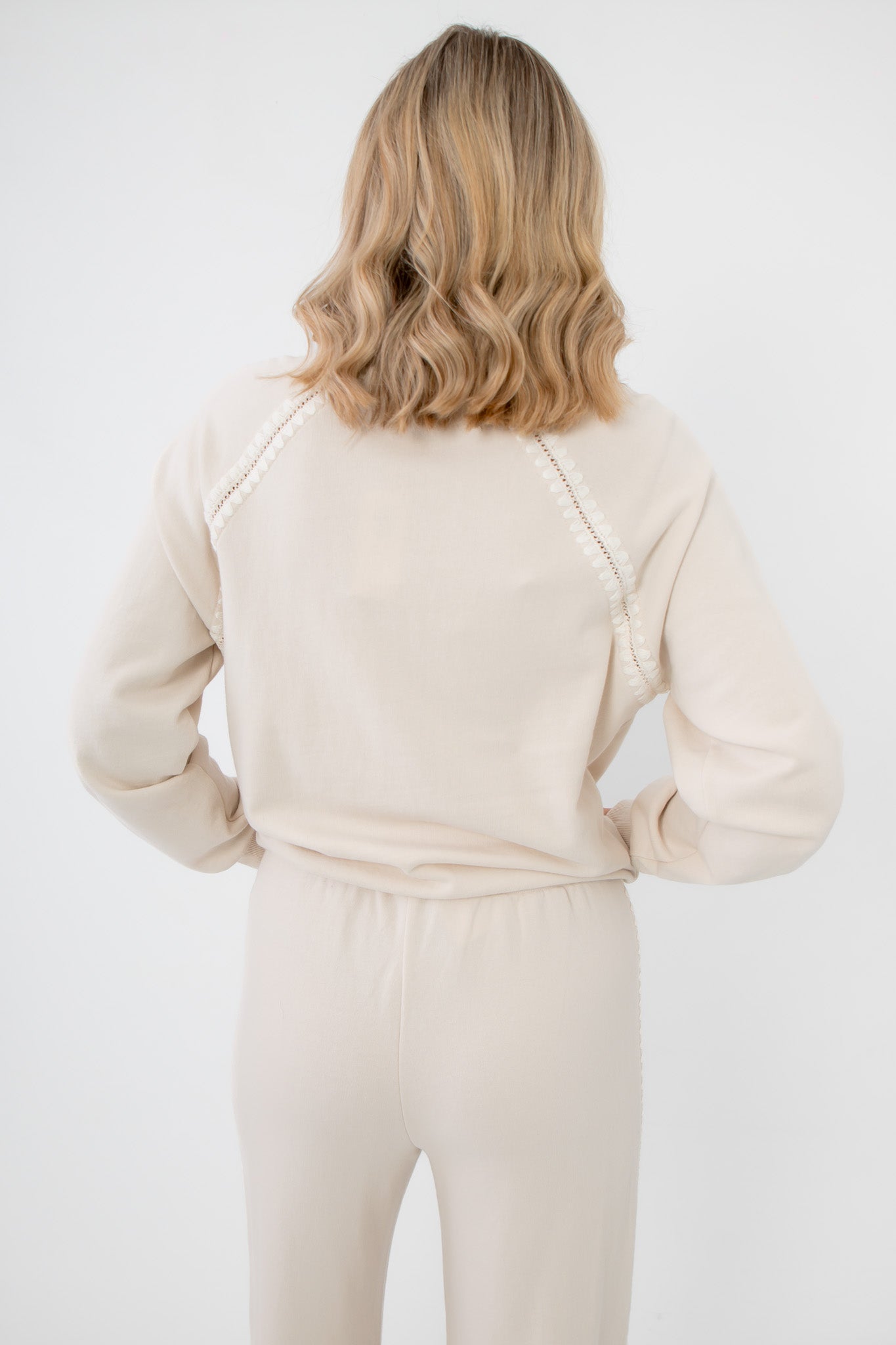 Back view of Z Supply Crystal All Around Sweatshirt showing pearl trim along raglan sleeves, soft cream fabric with relaxed silhouette.