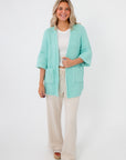 Cozy Mint Sorbet Chenille Slouch Cardigan styled with neutral loungewear, showcasing its oversized sleeves and textured knit design.
