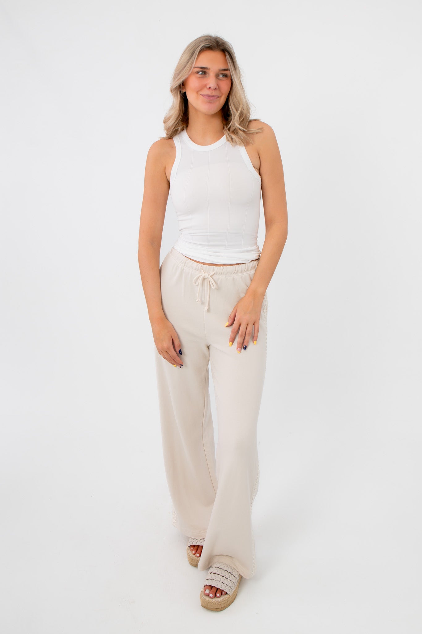 Lightweight Free People Clean Ivory Seamless Modal Tank styled with beige lounge pants, perfect for casual and breathable everyday wear.