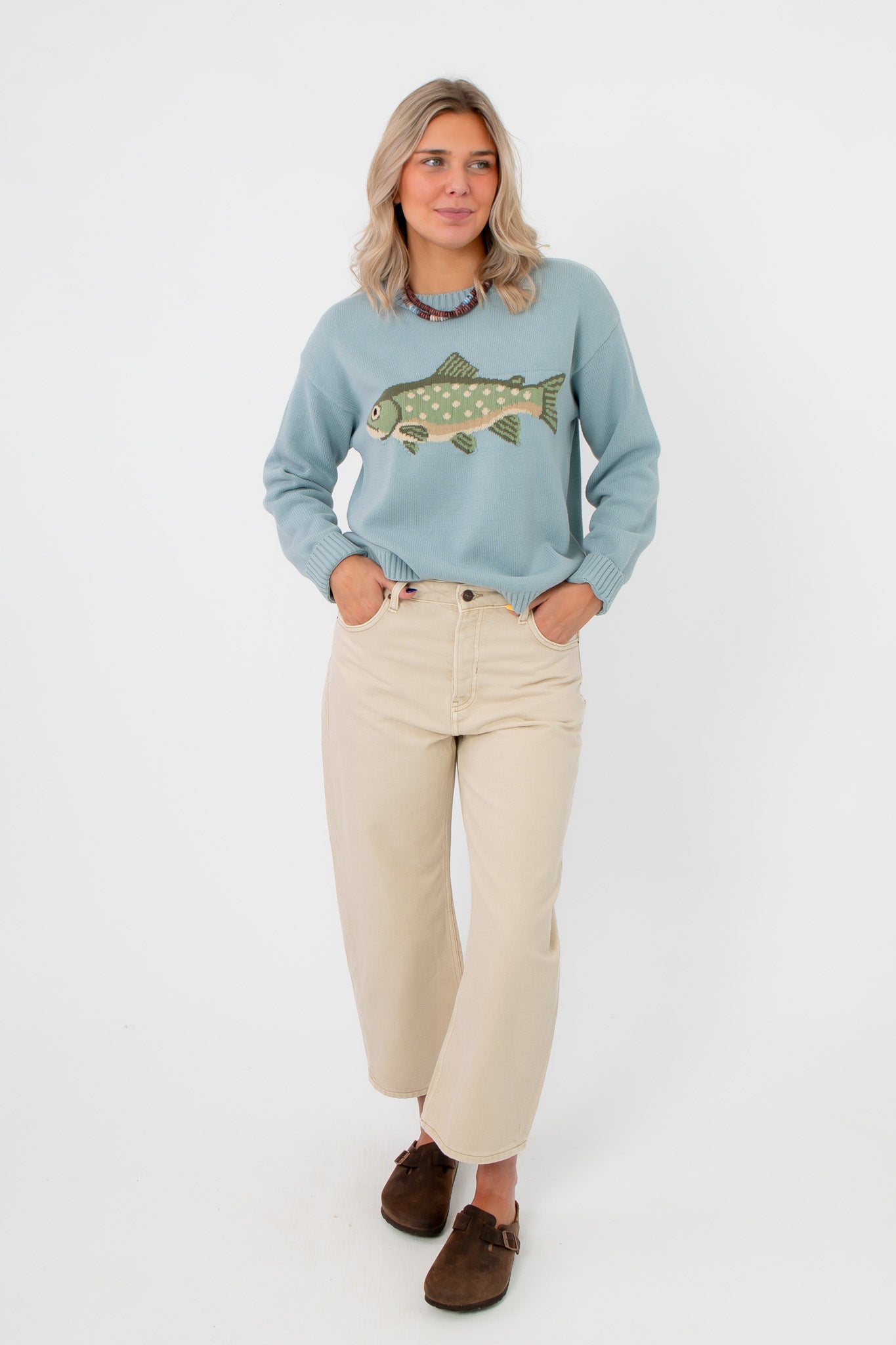 Catch of the Day Knit Fish Sweater in cozy sage green with fish graphic, styled with cream wide-leg pants for a casual, trendy look.