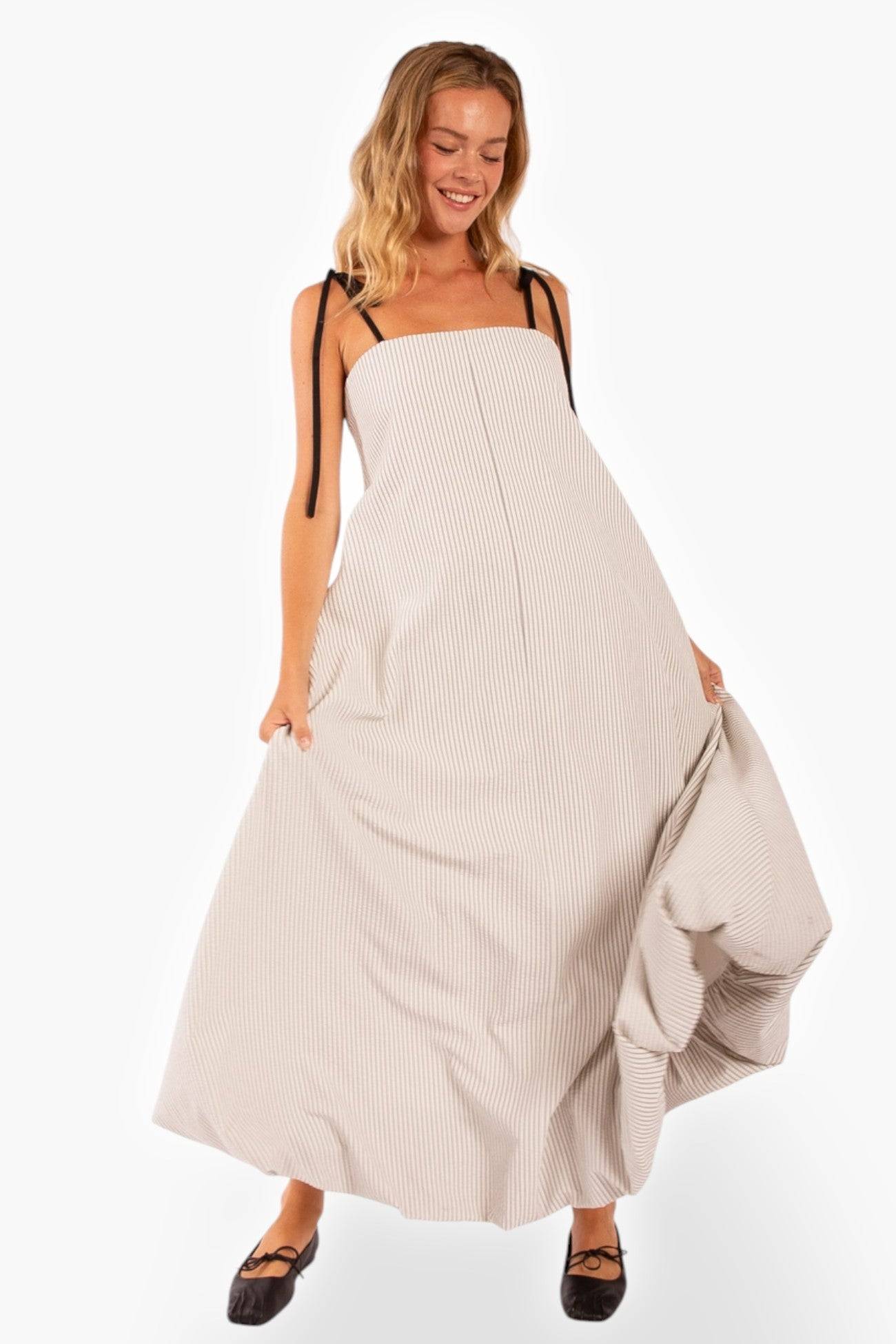 Shoreline Striped Maxi Dress with bubble hem and black adjustable straps. Features a relaxed fit and flowy silhouette, perfect for warm weather.